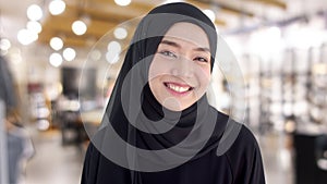 Portrait beautiful Muslim woman wearing traditional clothing smiling with shyness