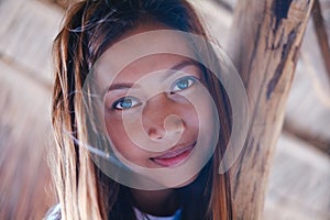 Portrait of a beautiful native Asian girl climbing on the sunshade umbrella