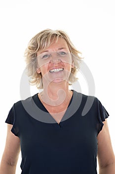 Portrait of beautiful naturally senior blond woman smiling and looking in camera on white background