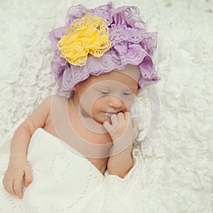Portrait of a beautiful newborn girl with Down syndrome