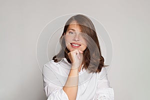 Portrait of beautiful nurse or doctor posing confidently while standing against white background