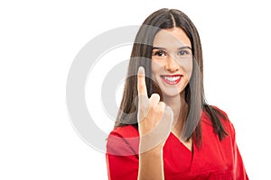 Portrait of beautiful nurse wearing red scrubs showing number one gesture
