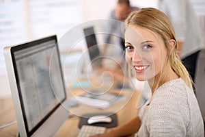 Portrait of beautiful office worker in computer