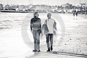 Portrait of beautiful older mom and mature daughter walking on t
