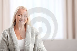 Portrait of beautiful older woman against blurred background