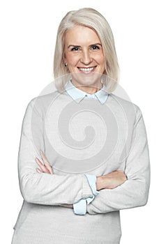 Portrait of a beautiful older woman smiling and standing with arms crossed