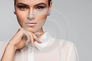 Portrait of a beautiful pacified woman in a white shirt. Studio photo session