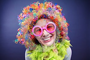 Portrait of beautiful party woman in wig and glasses Carneval