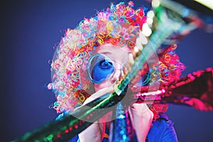 Portrait of beautiful party woman in wig and glasses Carneval