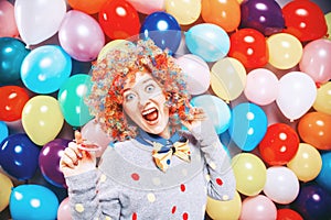 Portrait of beautiful party woman in wig and glasses Carneval