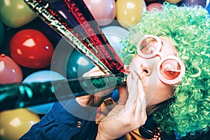 Portrait of beautiful party woman in wig and glasses Carneval