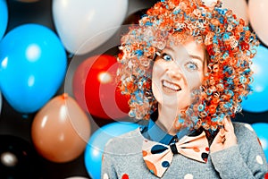 Portrait of beautiful party woman in wig and glasses Carneval