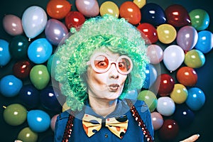 Portrait of beautiful party woman in wig and glasses Carneval