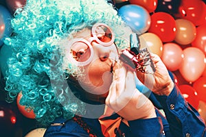 Portrait of beautiful party woman in wig and glasses Carneval