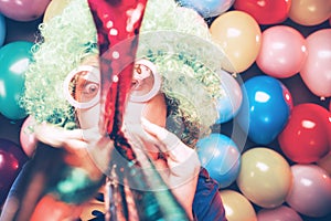 Portrait of beautiful party woman in wig and glasses Carneval