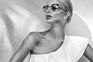 Portrait beautiful phenomenal stunning elegant blonde model woman with perfect face wearing a sunglasses