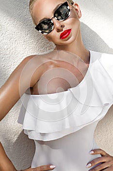 Portrait beautiful phenomenal stunning elegant blonde model woman with perfect face wearing a sunglasses
