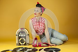 Portrait beautiful pin up listening to music on an old jukebox r