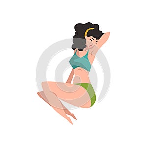 Portrait of beautiful pin-up model in lying position. Pretty young girl in retro swimwear with black curly hair. Smiling
