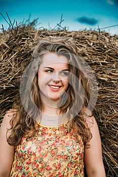 Beautiful Plus Size Young Woman Standing Near Hay Bale In Summer