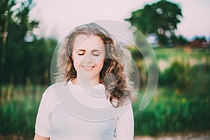 Portrait Of Beautiful Plus Size Young Woman In White Shirt Posing In Summer Field Meadow At Sunset Background