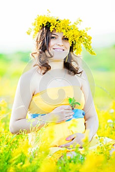 Portrait of a beautiful pregnant woman in the countryside