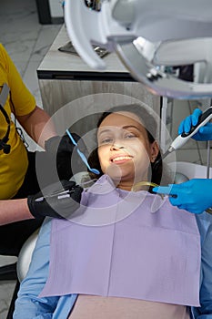 Portrait of a beautiful pregnant woman in dentist& x27;s chair getting dental examination and treatment in dentistry