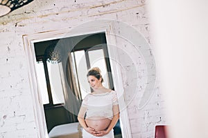 Portrait of a beautiful pregnant woman at home