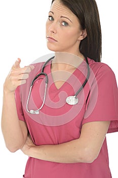 Portrait Of A Beautiful Professional Serious Concerned Young Female Doctor Pointing in Disappointment