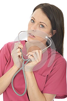 Portrait Of A Beautiful Professional Serious Young Female Doctor Putting On A Stethoscope