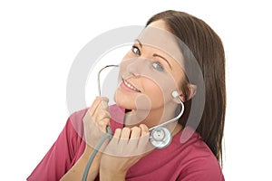 Portrait Of A Beautiful Professional Young Female Doctor Putting On A Stethoscope