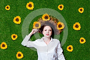 Portrait of beautiful red-haired girl with sunflowers