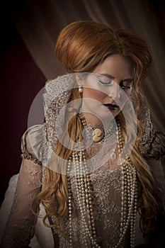 Portrait of beautiful red haired woman dressed in period costume as Elizabeth I