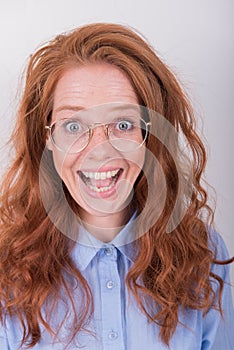 Portrait of beautiful, red-haired woman with glasses