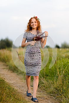 Portrait of a beautiful redhead girl in a black and white dress.