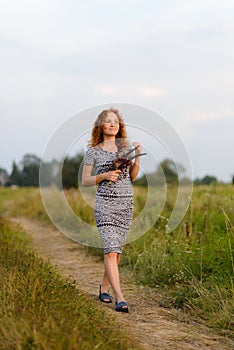 Portrait of a beautiful redhead girl in a black and white dress.