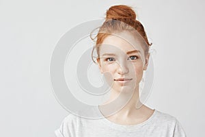 Portrait of beautiful redhead girl smiling looking at camera.