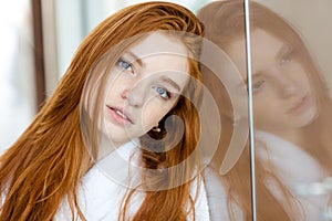 Portrait of a beautiful redhead woman in bathrob