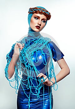 Portrait of beautiful redhead woman with blue threads