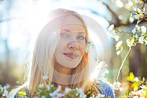 Portrait of beautiful romantic mysterious blond hair woman enjoying warm spring sunny day