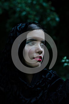 Portrait of beautiful sad girl outdoor on dark summer day