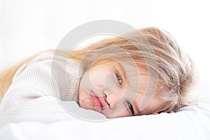 portrait of beautiful sad little child girl with blonde hair and big eyes