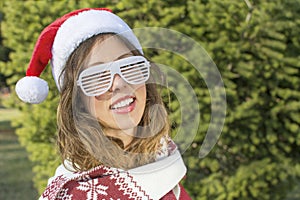 Portrait of a beautiful Santa Claus girl with party glasses