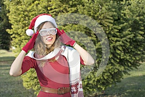 Portrait of a beautiful Santa Claus girl with party glasses