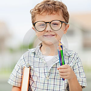 Portrait of Beautiful school boy looking very happy outdoors at