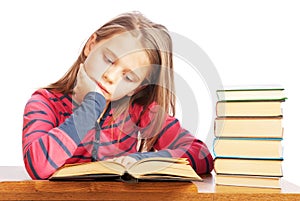 Portrait of a beautiful schoolgirl reading a book