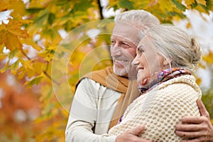 Portrait of beautiful senior couple hugging in the park