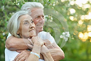 Portrait of beautiful senior couple hugging in the park