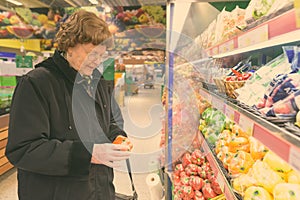 Beautiful senior woman shopping at the grocery store