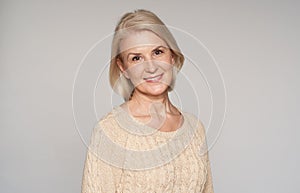 Portrait of beautiful senior woman smiling. 50 years old blonde lady